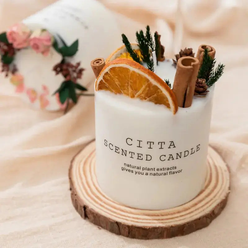 Creative Soy Wax Romantic Aromatherapy Candles by Zendrop showcasing a scented candle adorned with dried citrus slices and decorative elements, presented on a natural wood base for a warm, inviting home decor.