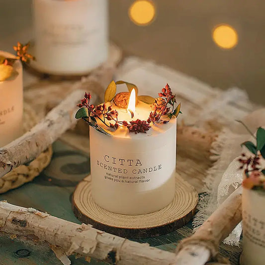 Creative Soy Wax Romantic Aromatherapy Candles by Zendrop featuring a beautifully decorated candle with flowers and greenery, set on a wooden slice, creating a charming and elegant atmosphere.