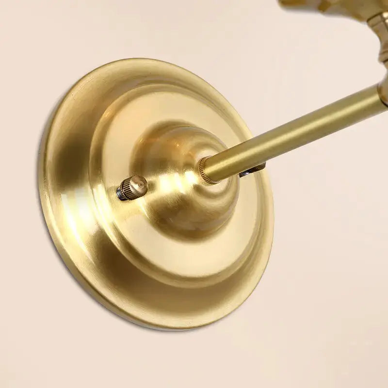 Close-up view of the brass base of the Classic Style Wall Light by Zendrop, showcasing the elegant design and finish.