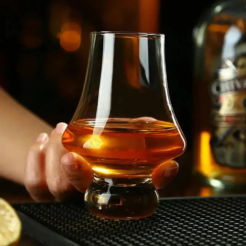 Crystal Tasting Glasses by Zendrop featuring a hand holding a glass filled with amber whisky, designed for enhancing sensory experiences.