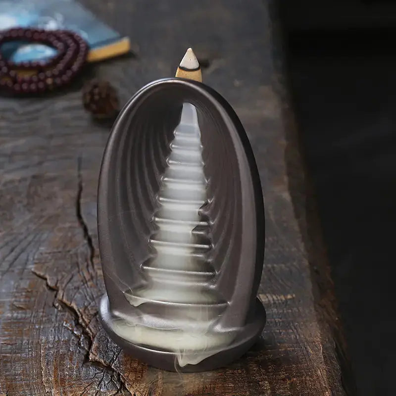 Side view of the Clay Waterfall Aromatherapy Incense Burner by Zendrop, featuring a unique design with aromatic smoke.