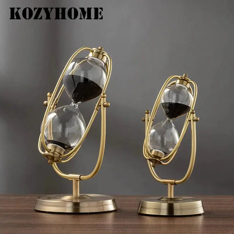 Aurelius Hourglass Timer by Zendrop displayed alongside a smaller version, both featuring a sophisticated brass finish and 360° rotating design.