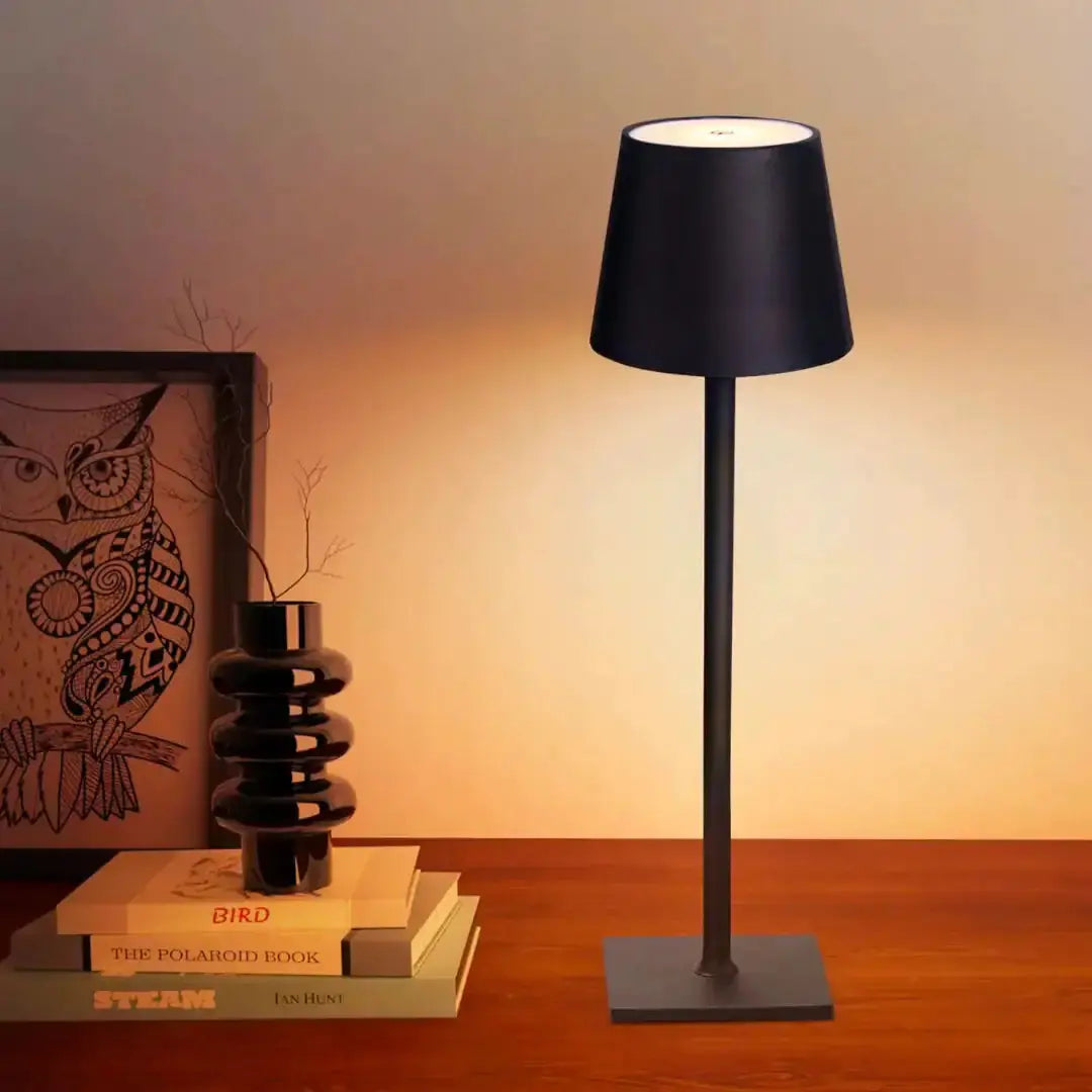 Stylish cordless lamp by Zendrop placed on a bedside table, casting a gentle glow, alongside decorative items in a cozy setting.