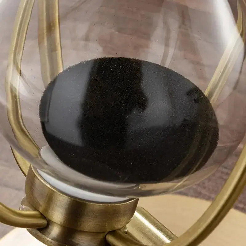 Close-up view of the black sand in the Aurelius Hourglass Timer by Zendrop, highlighting its precision and elegant design.