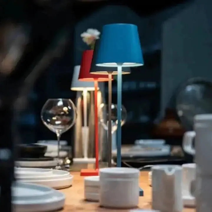 Colorful cordless lamps illuminated on a dining table, adding a vibrant touch to the dining experience, by Zendrop.